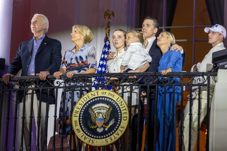 WASHINGTON, DC - JULY 04: (L-R) President Joe Biden, first lady Jill Biden, Finnegan Biden holding Beau Biden, Hunter Biden, Melissa Cohen and Peter Neal watch fireworks on the South Lawn of the White House on July 04, 2023 in Washington, DC. The Bidens hosted a Fourth of July BBQ and concert with military families and other guests on the South Lawn of the White House.