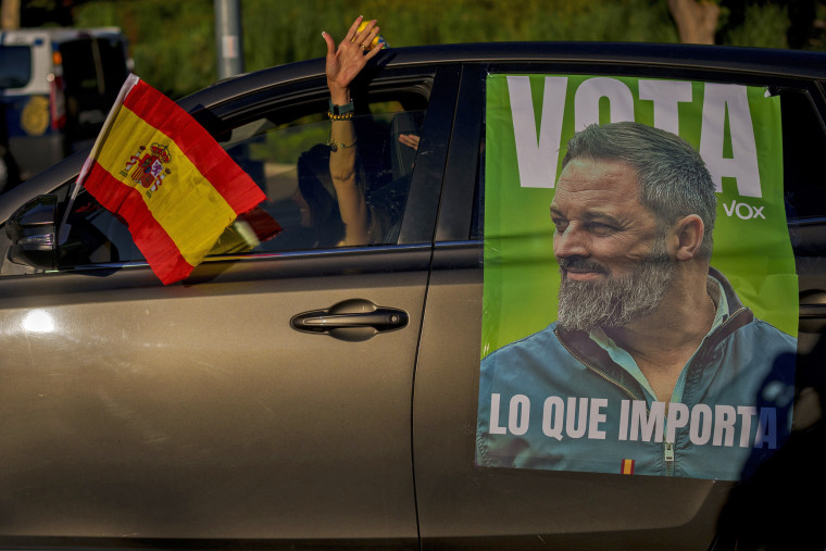 A woman drives her car with a picture of the VOX far-right party leader Santiago Abascal before an election campaign event in Guadalajara, Spain, on July 15, 2023.