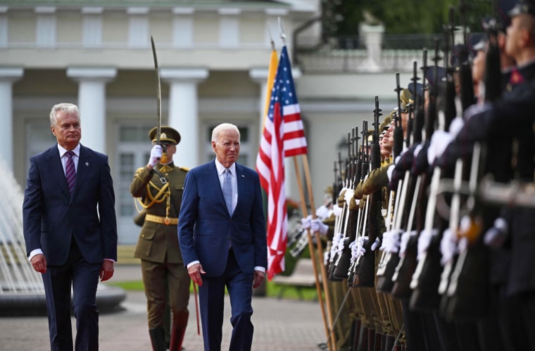 President Joe Biden walks with Lithuanian President Gitanas Nauseda during an official welcome ceremony at the Presidential Palace in Vilnius, Lithuania