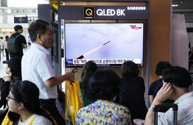 People watch a news program about North Korea's missile launch at the Seoul Railway Station