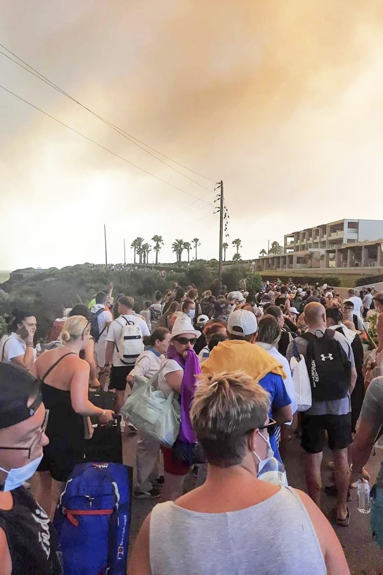 Tourists are evacuated during a forest fire on the island of Rhodes, Greece
