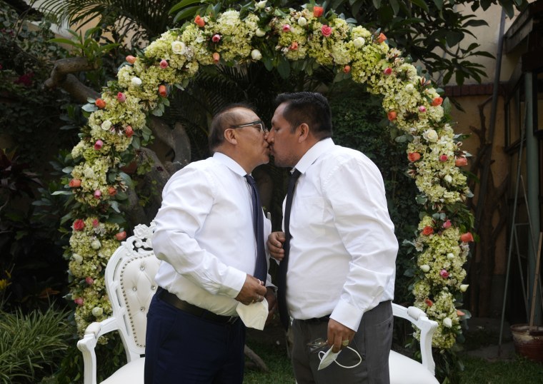 Juan Alfonso, left, kisses his partner Miguel Angel during a symbolic gay wedding ceremony, organized by Peru's LGBT community to promote same-sex marriage, in Lima, Peru