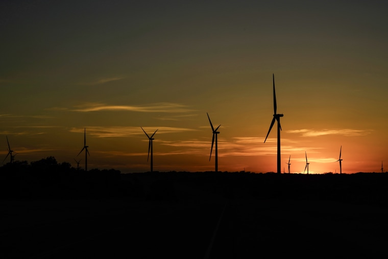Wind turbines work at sunset on a wind farm near Del Rio, Texas on Feb. 15, 2023. 
