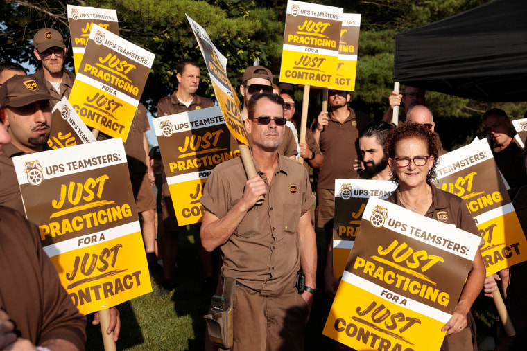 UPS workers and Teamsters members practice picket outside a UPS distribution facility in Madison Heights, Mich., on July 18, 2023. 