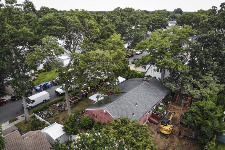 Image: Authorities continue to work at the home of suspect Rex Heuermann, bottom right, in Massapequa Park, N.Y., on July 24, 2023.