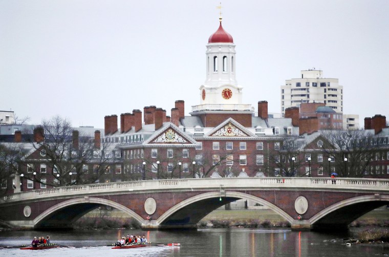 In this March 7, 2017, file photo, rowers paddle along the Charles River past the Harvard University campus in Cambridge, Mass. A federal appeals court on Thursday, Nov. 12, 2020 has upheld a district court decision clearing Harvard University of intentional discrimination against Asian American applicants.