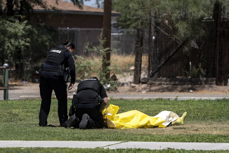 Image: Tucson police officers tend to an unhoused deceased person whose body temperature was 102 degrees Fahrenheit at the time of discovery at Estevan Park in Tucson