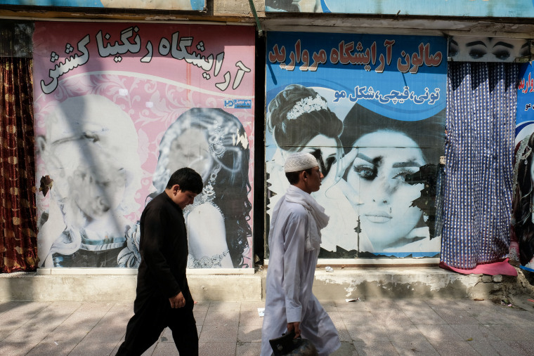 Defaced faces of women appear on the windows of hair and beauty salons on the airport road  in Kabul, Afghanistan on September 19, 2021. 