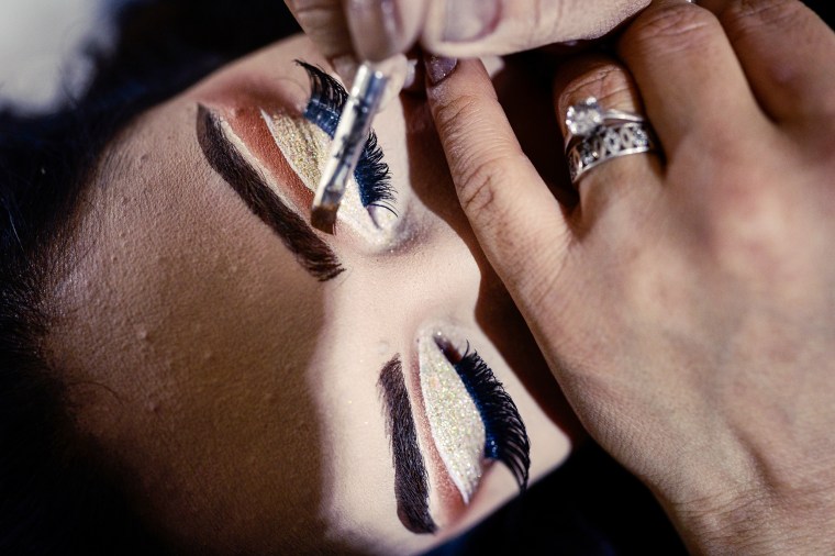 A woman has her makeup done in a beauty salon before a wedding ceremony in Kabuls Shar-e-Naw neighborhood on December 15, 2022.