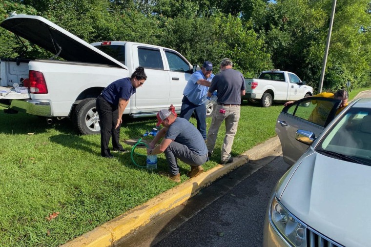 Staff from the City of Germantown's Engineering Department and the Town of Collierville provide residents with potable water at Bailey Station Elementary School in Collierville, Tenn.