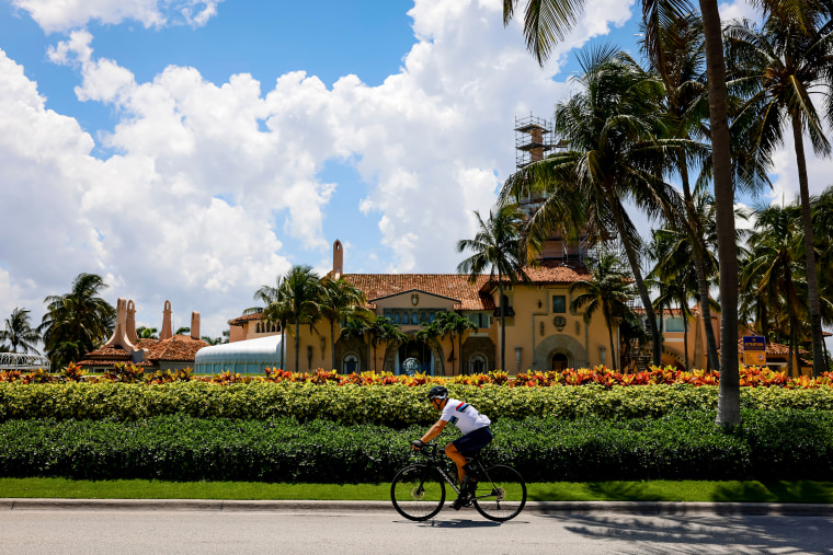 A cyclist rides past the Mar-a-Lago Club in Palm Beach, Fla., on June 11, 2023.