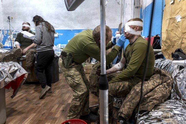 A Ukrainian Army doctor from the 72nd Mechanized Brigade tends to an injured soldier's wounds, in Donbas, Ukraine