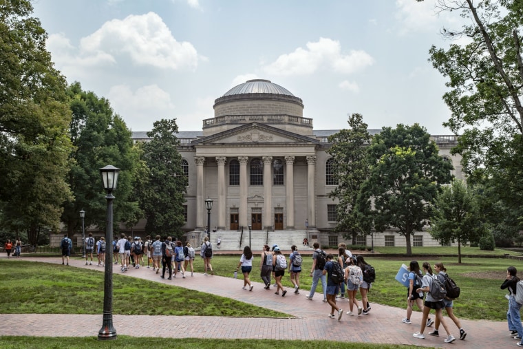 Image: Students walk across the University of North Carolina Chapel Hill Campus on June 29.