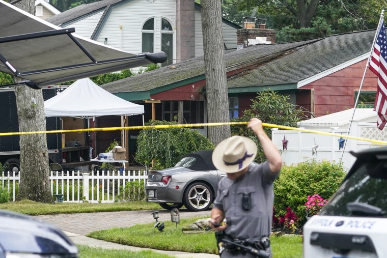 Authorities work outside as they search the home of Rex Heuermann in New York