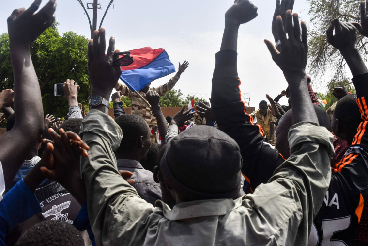 Protesters cheer Nigerien troops as they gather in front of the French Embassy in Niamey during a demonstration that followed a rally in support of Niger's junta on July 30, 2023.