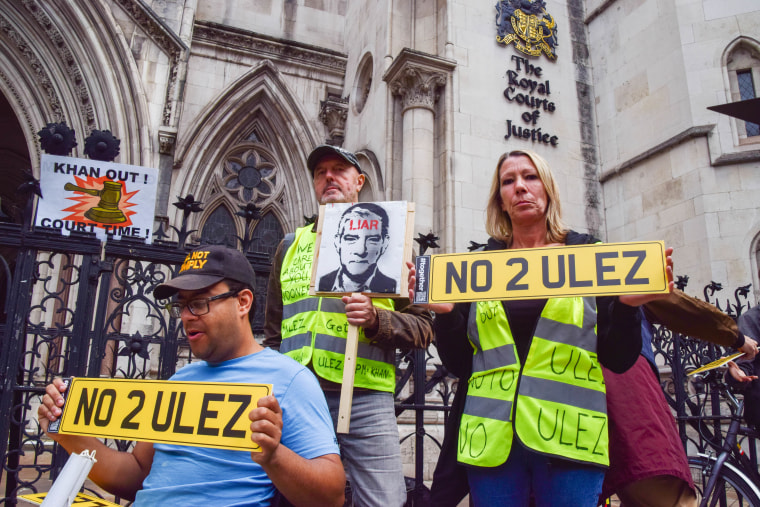 Protesters hold anti-ULEZ placards during the demonstration