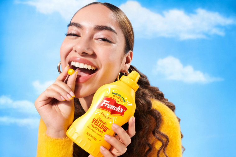 French’s Mustard Skittles, a candy this young lady is definitely enjoying to this exact level of excitement.