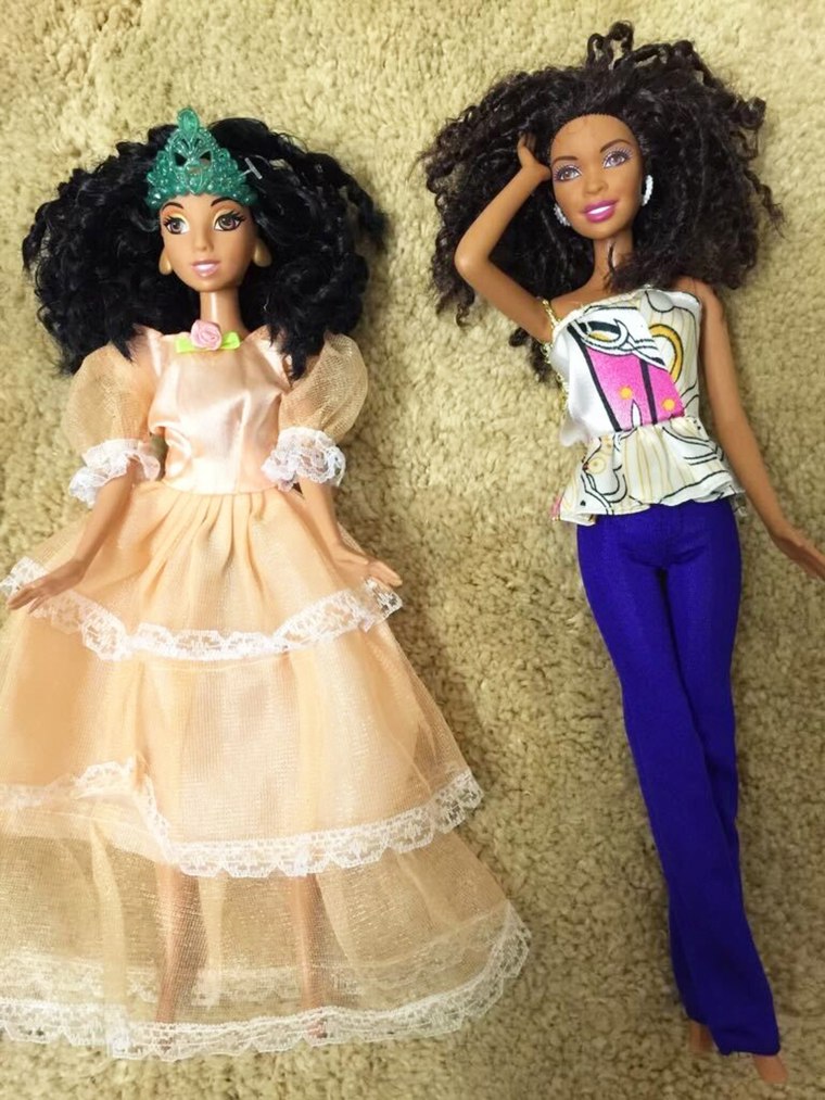 Angela Williams shows off two of her daughter's Barbie dolls.