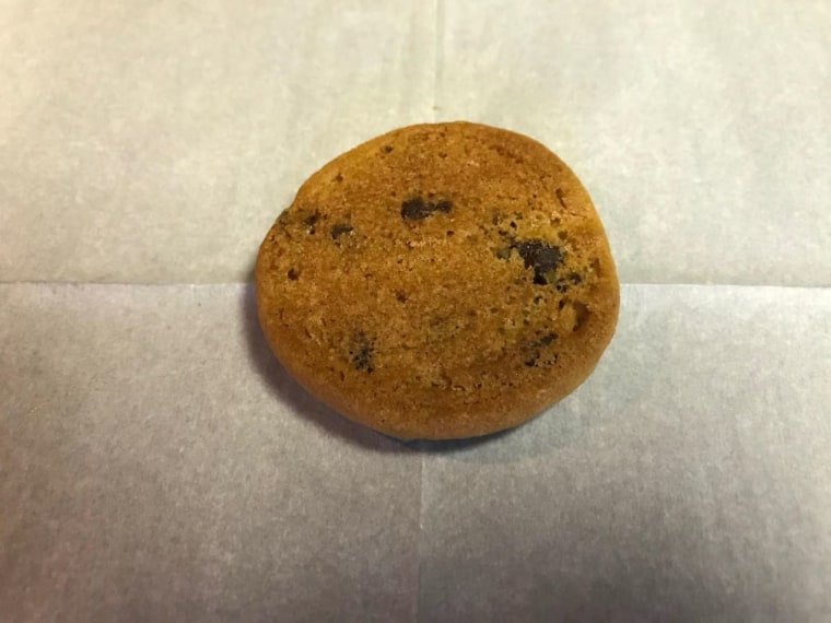 The Redditor says that this is one of the car cookies cooked properly in an oven, to show the difference in color from when baked in a car.