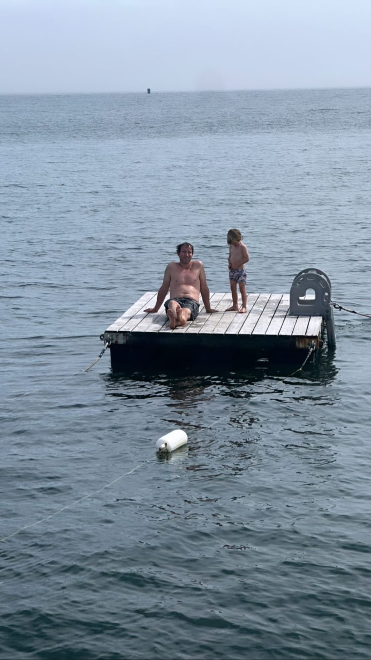 Jenna Bush Hager's husband, Henry, and their son, Hal, relax on a dock after a swim.