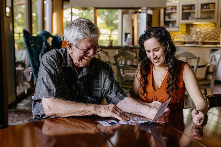 Fred Vollman and Olivia Savoie at the home of Mr. Vollman in Bunkie, La. looking over old family photographs. Olivia Savoie was commissioned to write the biography and family history for Mr. Vollman which turned into a friendship after the two bonded during the process.