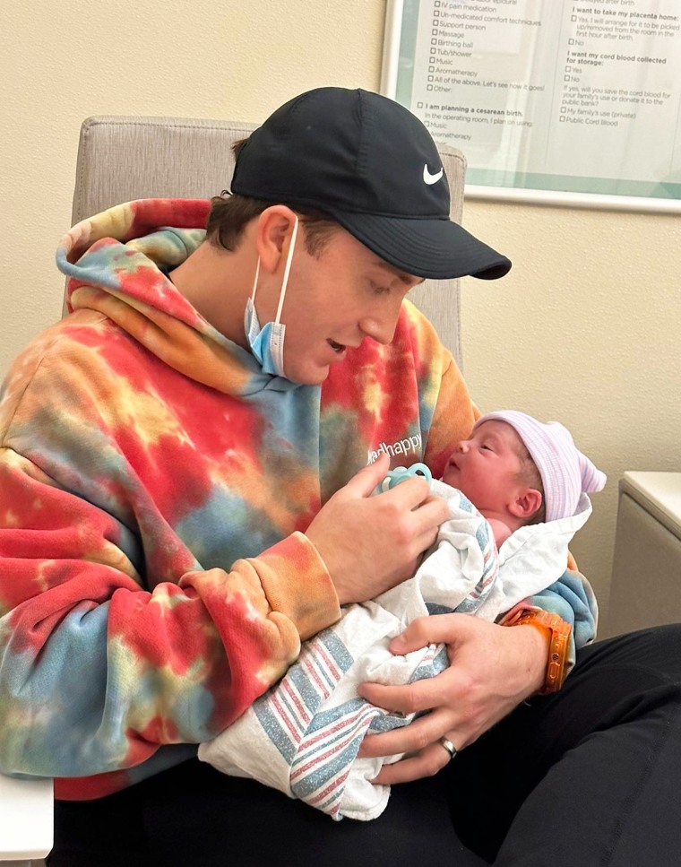 Meghan Trainor's husband and "Spy Kids" actor, Daryl Sabara, hold their new baby, Barry, in his arms.