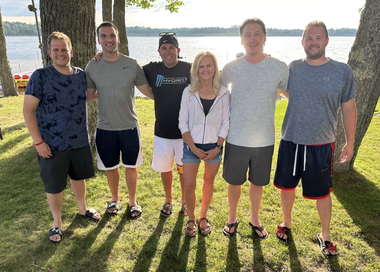 L-R: Tim Child, Zach Hurth, Ryan Meerschaert, Mary Theut, Paul Reynolds, and Brad Meyers. The five men surprised their mother-in-law Theut with a mother-son wedding dance.