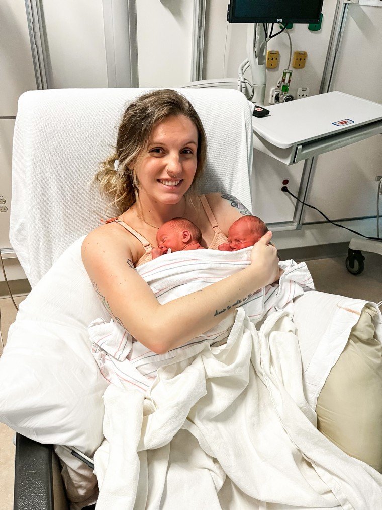 Mom of three Meghan Huston, holding both of her newborn twin boys for the first time.