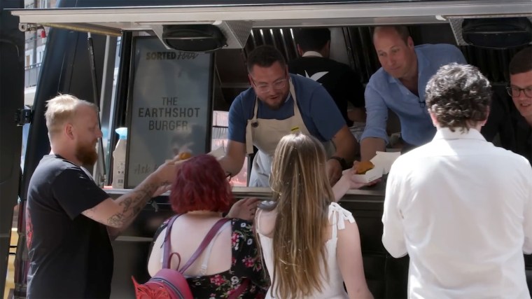 Prince William serving a special Earthshot Burger to a surprised group of customers alongside the Sorted Food crew.