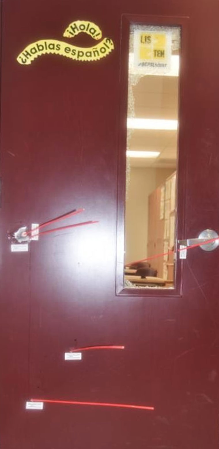 A photo of a classroom door inside Marjory Stoneman Douglas High School, riddled with bullet holes.