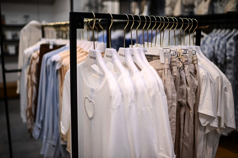 Clothes are displayed on hangers Shein pop-up store in Paris, on May 4, 2023.