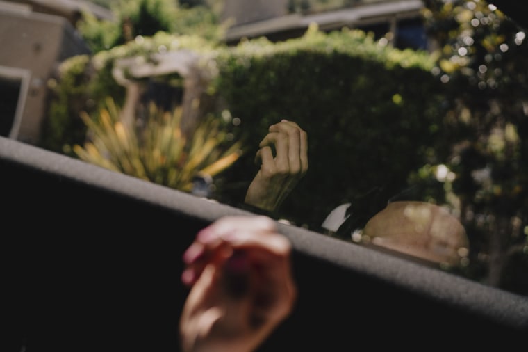 Desiree Townsend’s hand reflected on a window during a car ride in Laguna Beach, California.