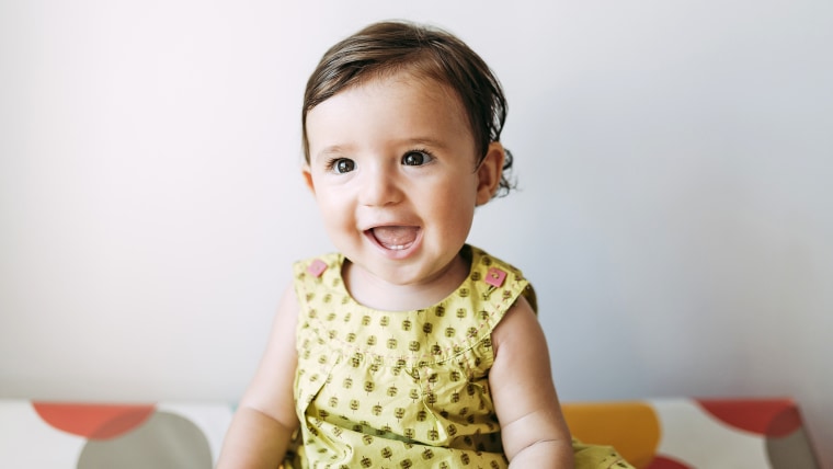 Portrait of happy baby girl wearing a dress