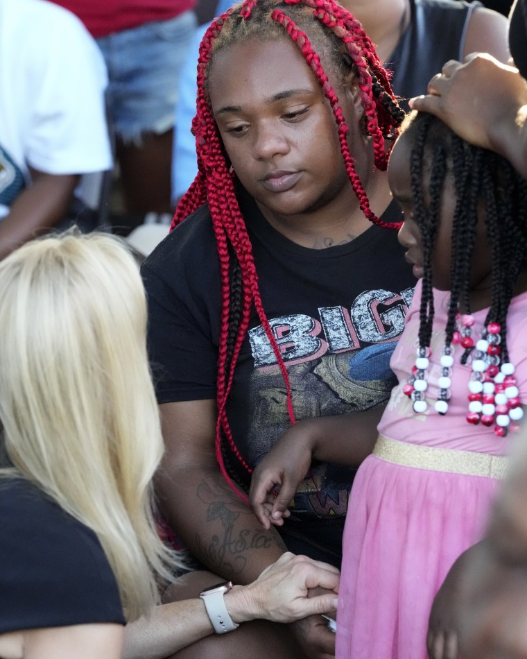 Mayor Donna Deegan comforts Tyesha Jones, the partner of Jarrald Gallion, who was killed in the Jacksonville mass shooting, and his daughter Je Asia at a prayer vigil Sunday.