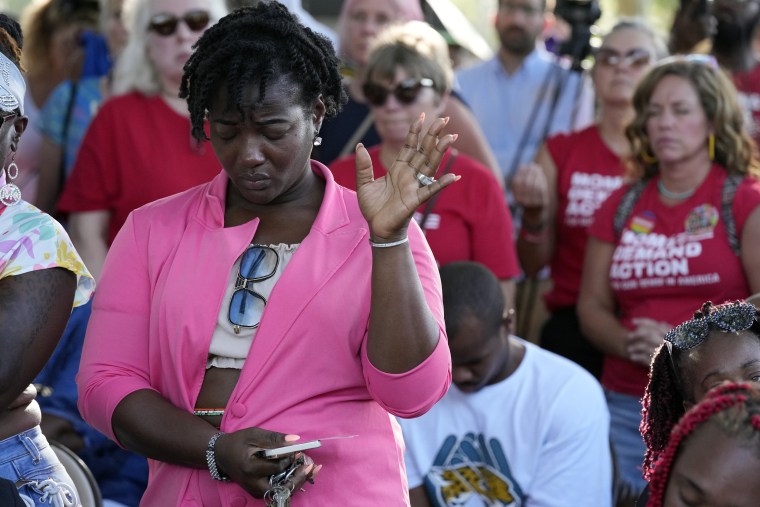 A woman attends a prayer vigil on Aug. 27, 2023, for the victims of the Jacksonville, Fla., mass shooting.