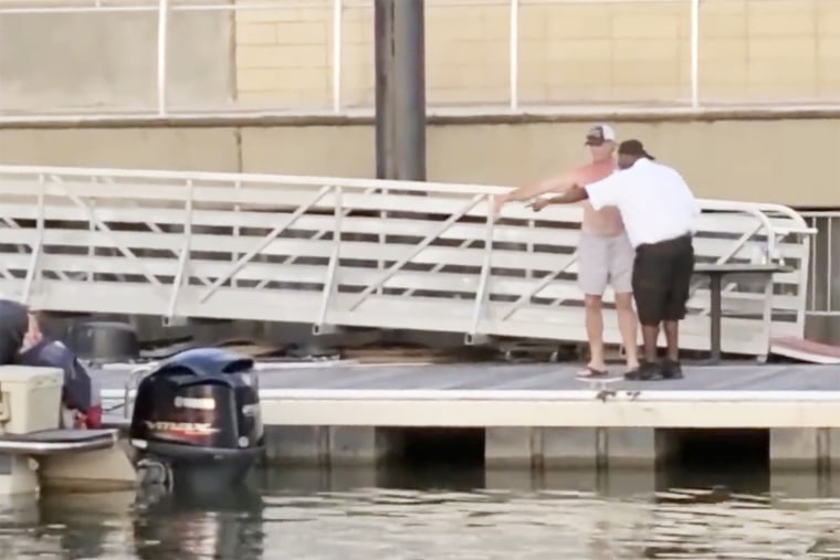 Two men discuss the location of a boat at the Montgomery Riverfront, Alabama, on Aug. 5, 2023.