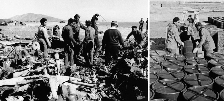 Workers sort through the wreckage and collect barrels of contaminated earth during the cleanup of an Air Force B-52 bomber carrying nuclear weapons that crashed off Palomares, Spain, in 1966.
