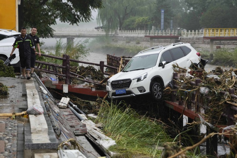 Chinese state media report some have died and others are missing amid flooding in the mountains surrounding the capital Beijing. (AP Photo/Ng Han Guan)