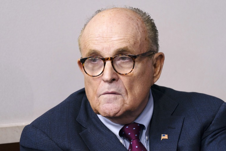 Rudy Giuliani, personal lawyer to U.S. President Donald Trump, listens as President Donald Trump speaks during a news conference in the James S. Brady Press Briefing Room at the White House in Washington, D.C., U.S., on Sunday, Sept. 27, 2020. Trump denied a report that he paid just $750 in federal income taxes in 2016 and 2017, and repeated his stance to only share his tax returns after an audit is finished.