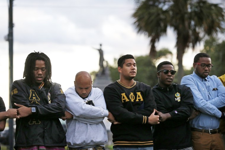 Graduate members of Alpha Phi Alpha Fraternity pray during a "social action prayer vigil" in New Orleans