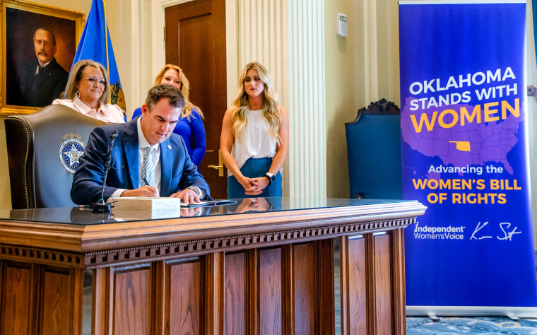 Oklahoma Gov. Kevin Stitt signs a bill narrowing the definition of "male" and "female" in Oklahoma City on Aug. 1, 2023.