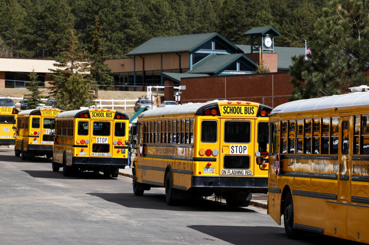 School busses arrive at Gateway Elementary School to pick up kids from school on April 12, 2023 in Woodland Park, Colo.