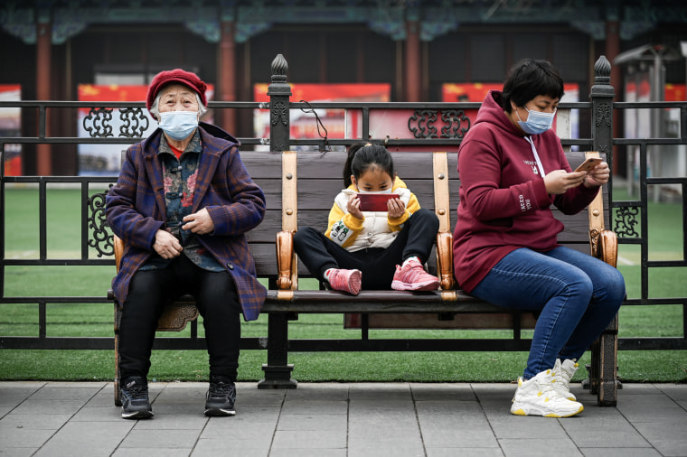 A girl uses a mobile phone in Beijing on March 4, 2021. 
