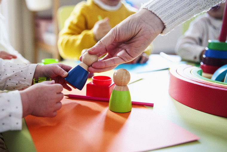 Preschool children playing with colorful shapes