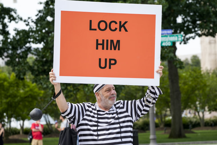 Domenic Santana, 61, of Miami, holds a sign that reads "Lock Him Up" at the E. Barrett Prettyman U.S. Federal Courthouse, on Aug. 3, 2023, in Washington.