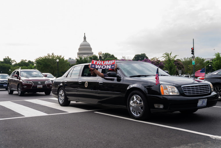 Supporters of former President Donald Trump ride a replica of the Presidential limousine in Washington, D.C.