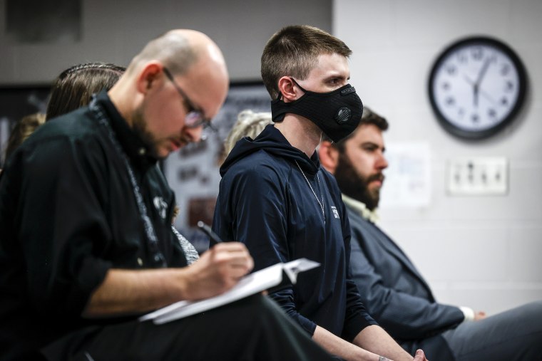 Logan Ruths, center, listens to the Woodland Park School District Board of Education meeting on April 12, 2023 in Woodland Park, Colo.