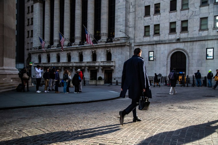 A man walks near Wall Street in New York on March 20, 2023.