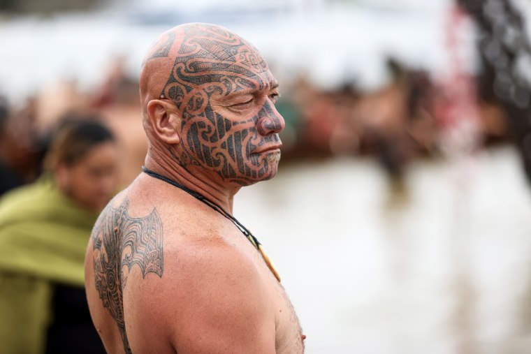 A man waits to welcome waka to the beach at Waitangi in Waitangi, New Zealand  on February 6, 2023.