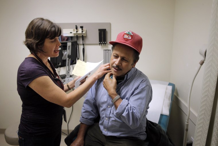 Image: A nurse practitioner gives a patient a check up during a visit at a clinic in Oakland, Calif., in 2017, which has seen an influx of low-income patients eligible for Medi-Cal, an expansion of Medicaid.